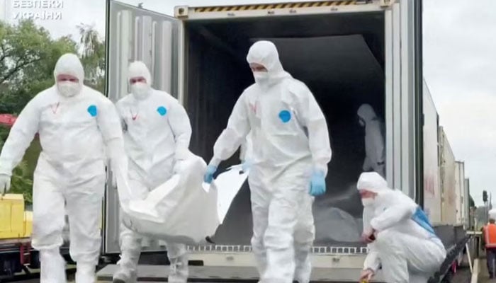 People in hazmat suits carry what is said to be remains of Ukrainian soldiers received from Russia in an unknown location in a screen grab from a Handout video released on June 13, 2025.—Reuters